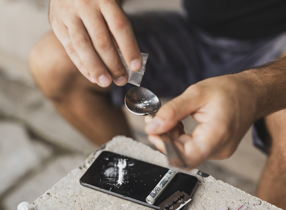 A man with heroin on a spoon