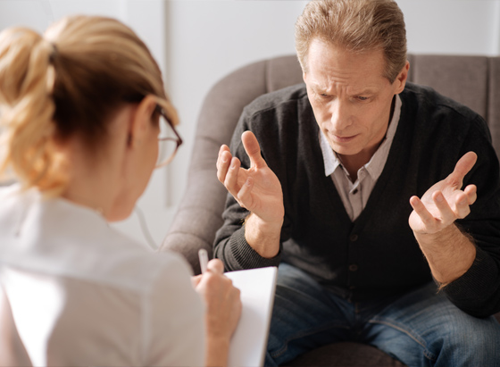 a man talking to a therapist about his challenges